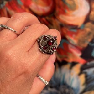 Sterling Silver “Poison” ring w/garnets. Opens with a secret compartment.